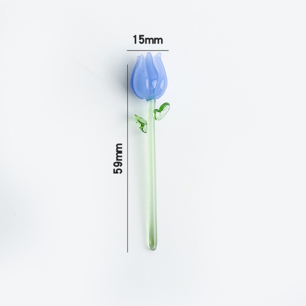 Mini glass rose placed on a wooden surface showing its delicate craftsmanship