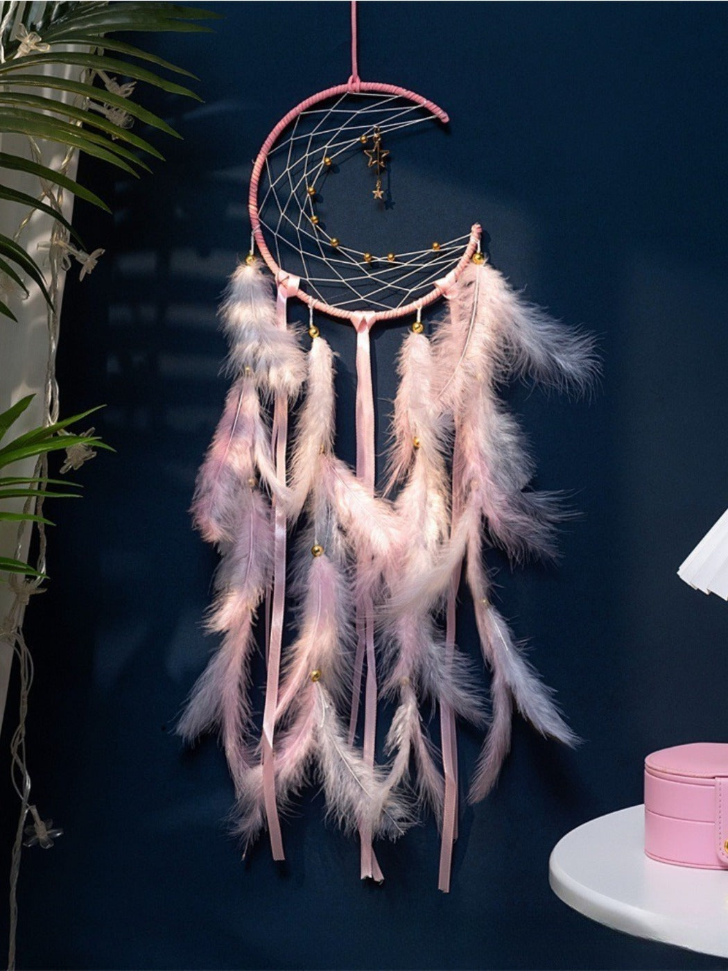 Side view of the Somnira dreamcatcher wind chime showing detailed beadwork and feather arrangement