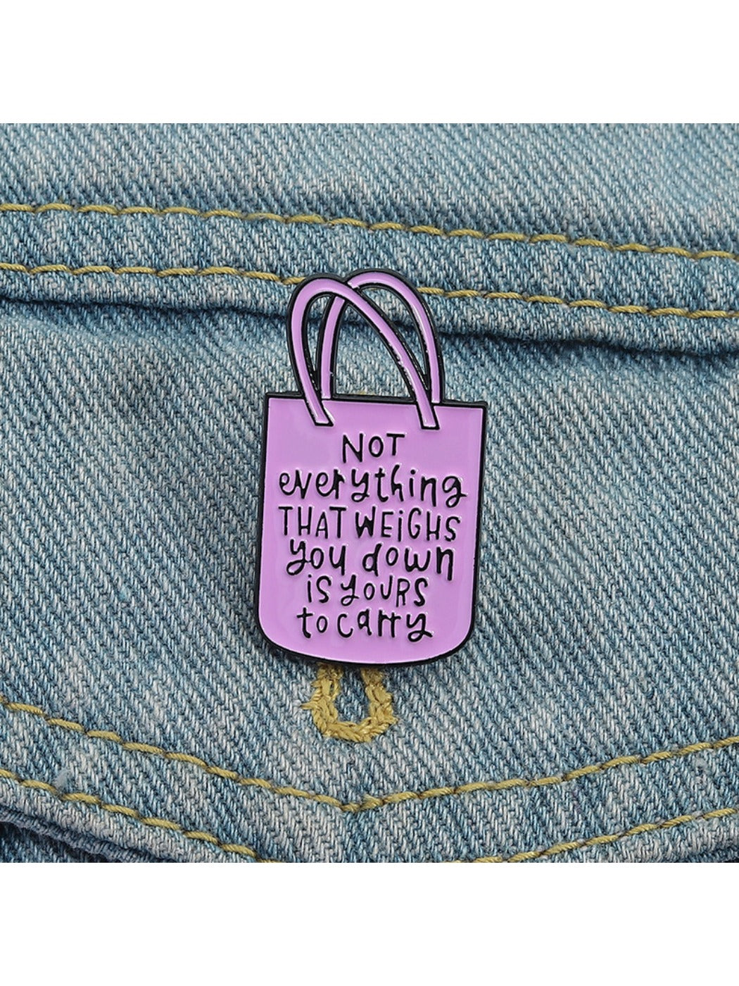 Close-up of Pinori pink tote bag brooch showing textured surface and gold chain