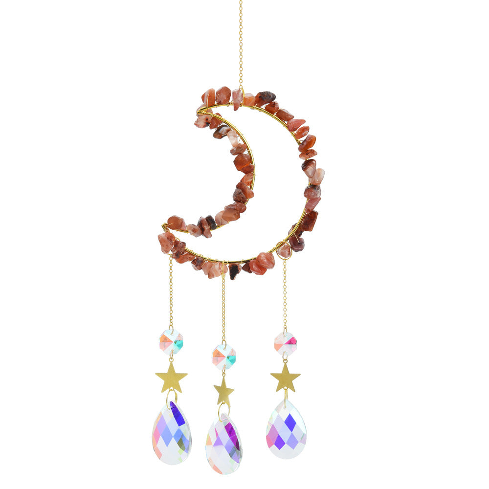 Somnira moon shaped dreamcatcher hanging from a branch with natural background