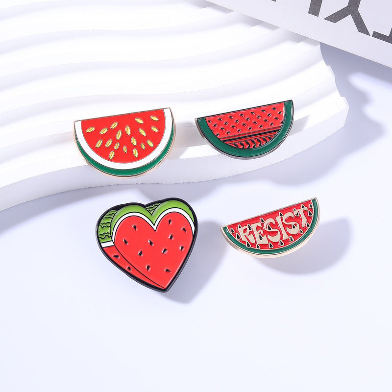 Multiple Styles watermelon enamel pins on white display blocks