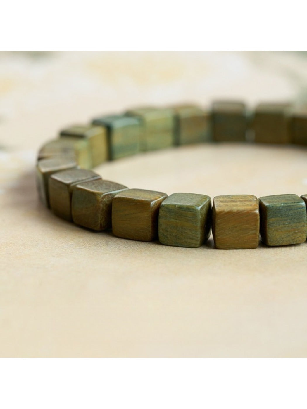 Side view of Emora green beaded bracelet highlighting bead texture