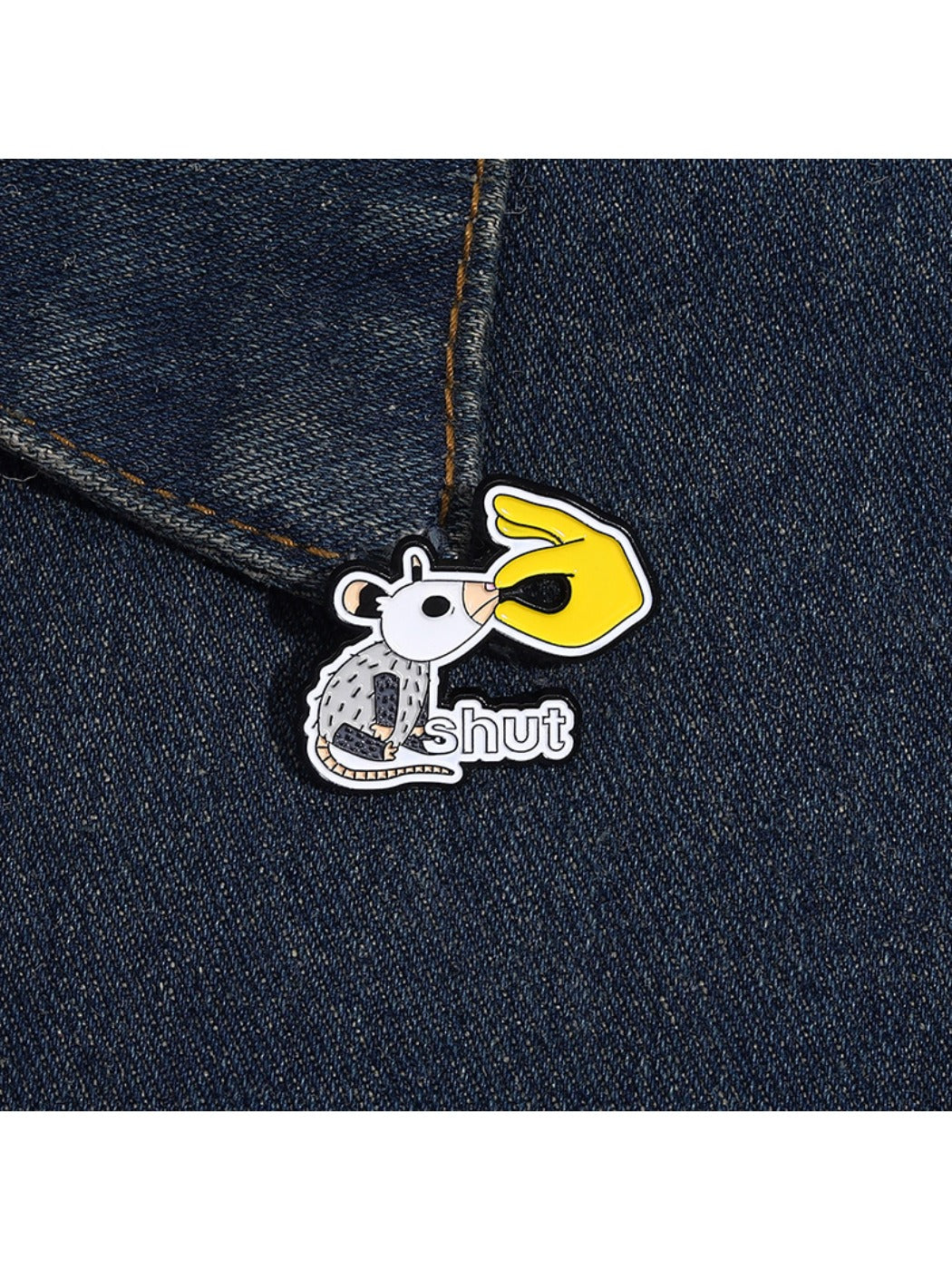 Pinori white lab rat pin badge held between fingers showing size