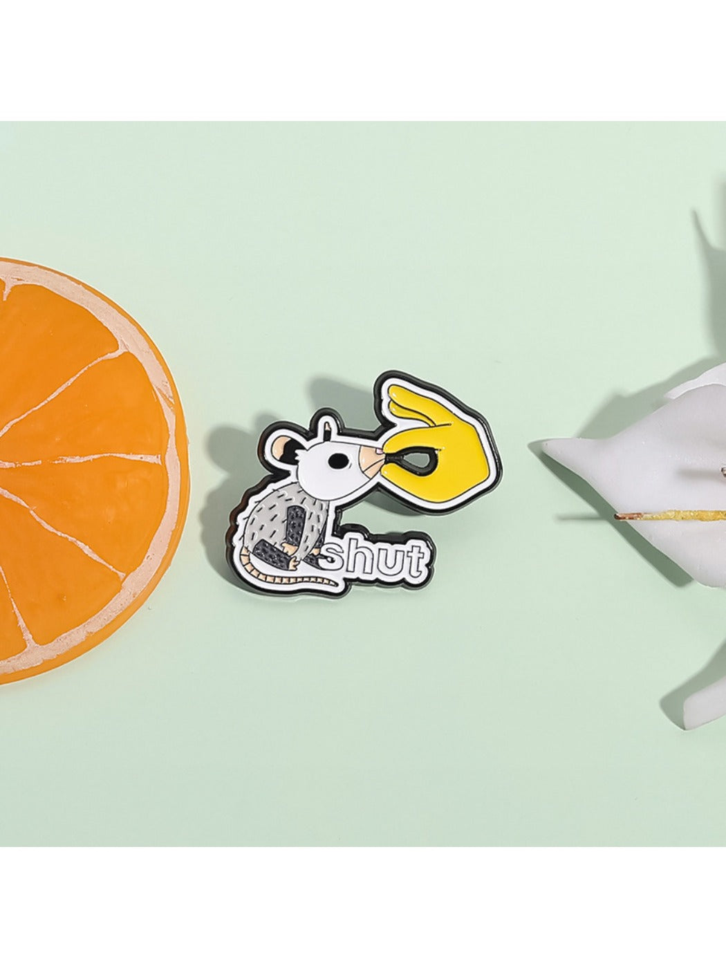 Pinori white lab rat pin badge displayed on a denim jacket pocket
