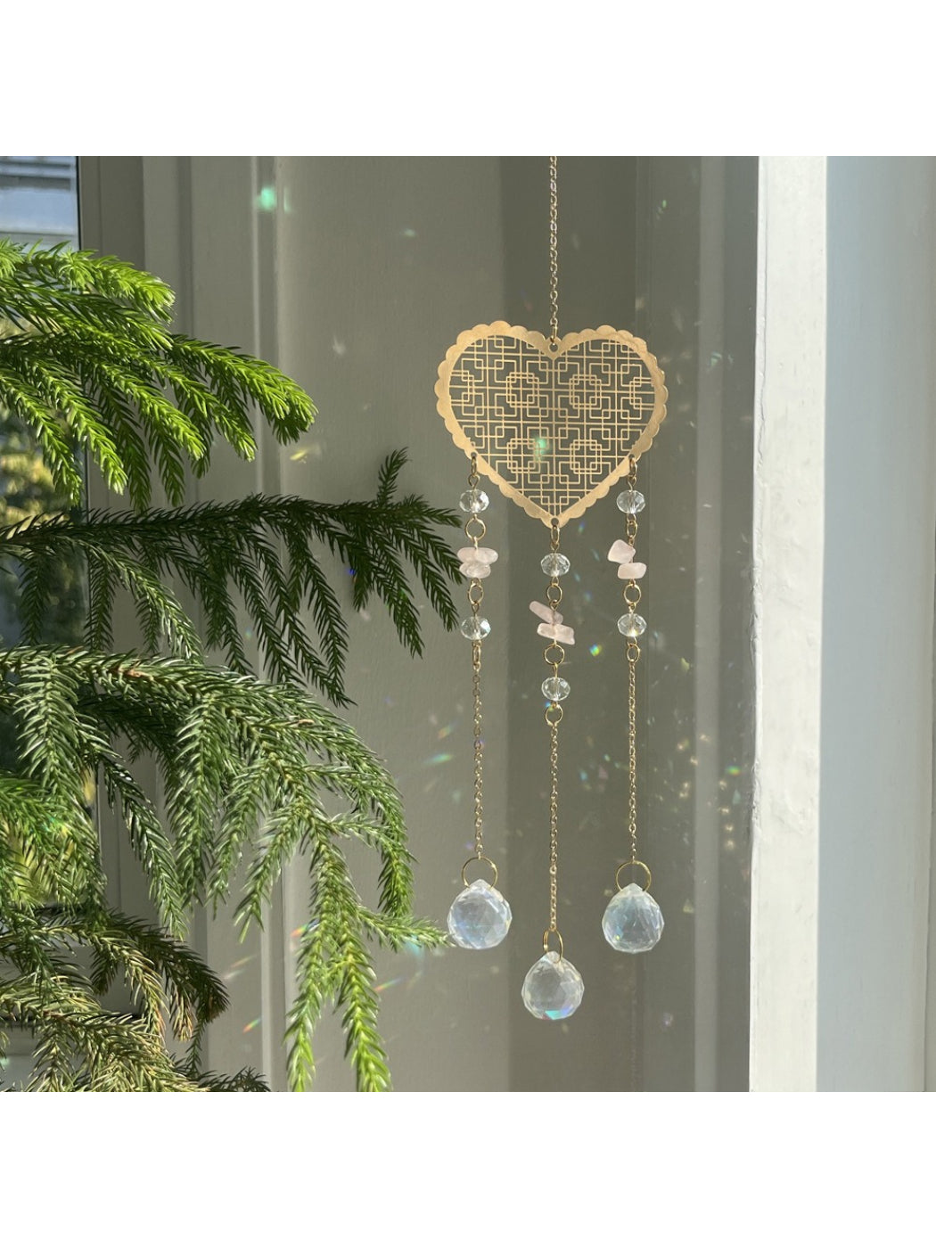 Somnia Heart Prism Hanging Sun Catcher casting rainbow light reflections