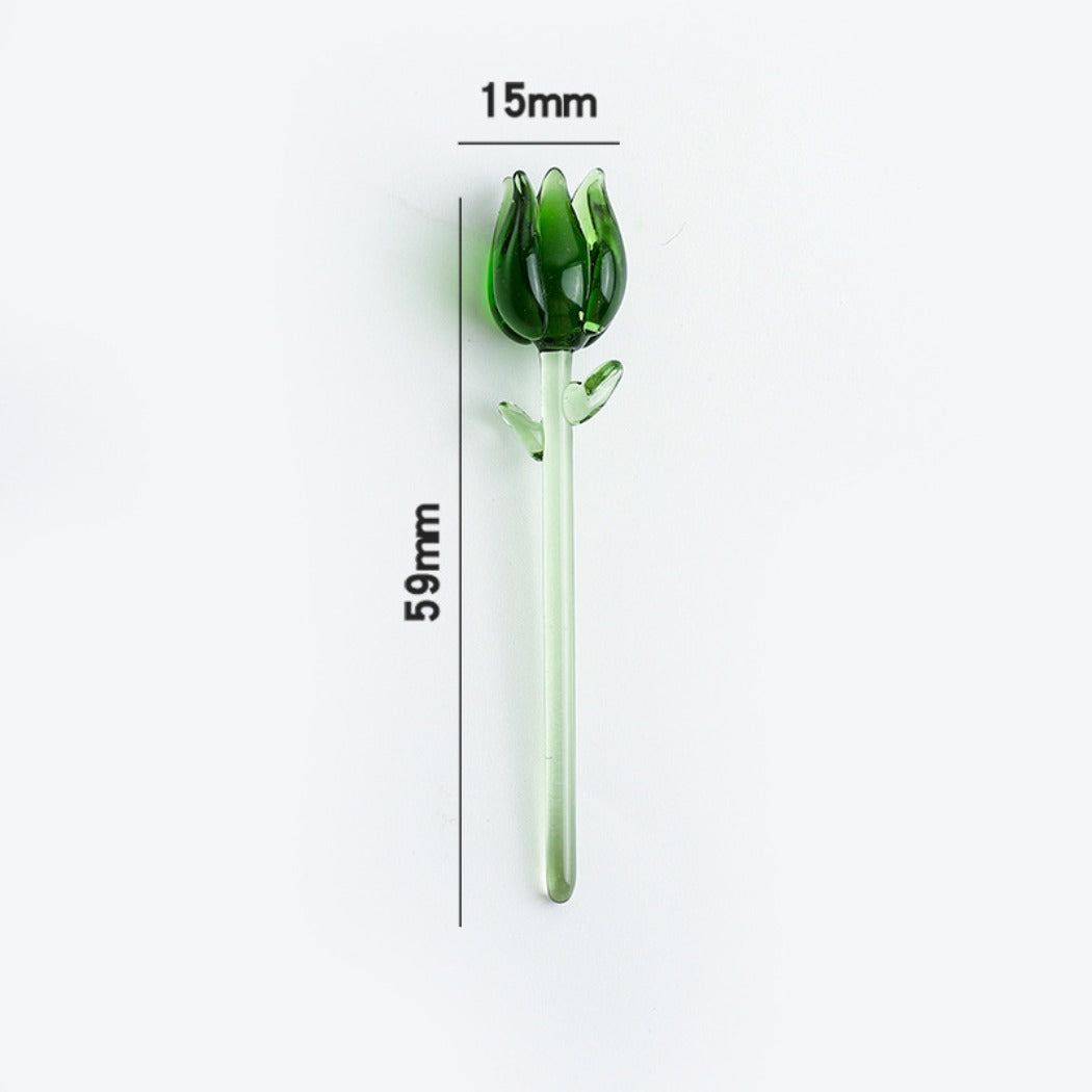 Hand holding a small Japanese glass rose with pink flower and green leaves