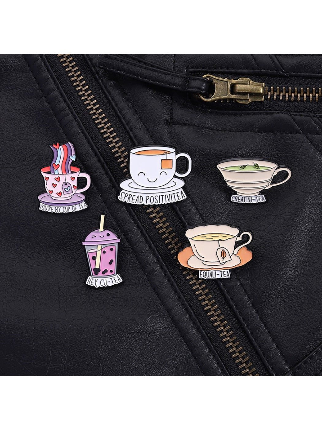 Pinori tea cup pin attached to a denim jacket pocket