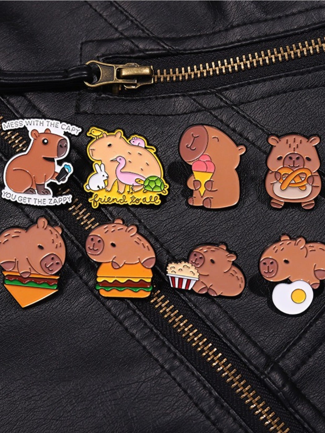 Pinori capybara hamburger brooch displayed on a jacket lapel