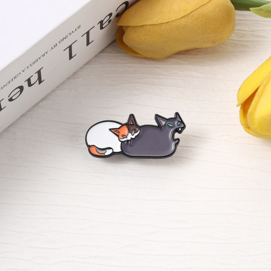 Pinori funny cat butt bite enamel pin showing a cartoon cat biting its own tail