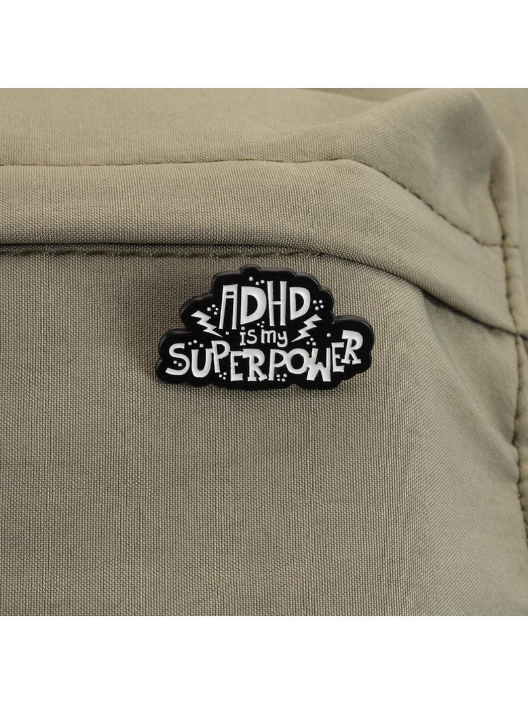 Pinori pin badge showing colorful text 'ADHD Is My Superpower' on a round white base