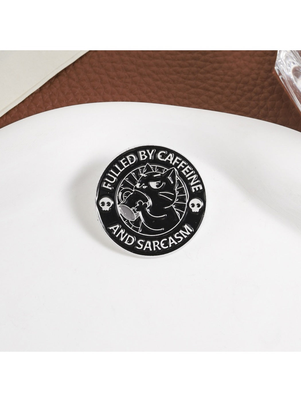 Side view of Pinori black cat coffee brooch highlighting metal edges