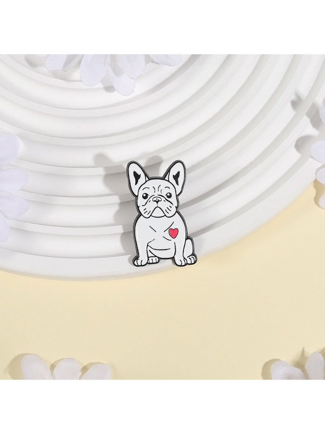 Close-up of Pinori white pug dog brooch showing detailed enamel and metal outline