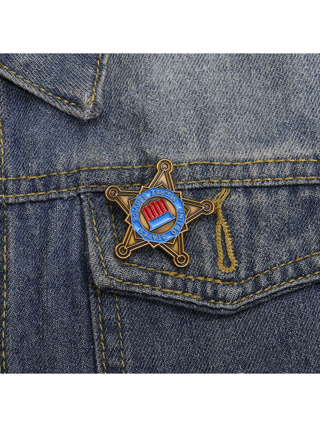 Pinori star brooch worn on a denim jacket lapel