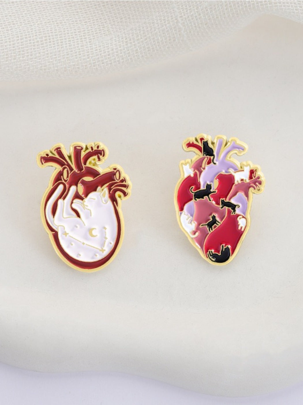 Close-up of Pinori cat heart anatomy brooch highlighting intricate heart pattern