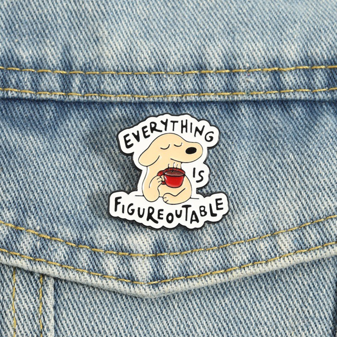 Pinori Figureoutable dog enamel pin displayed on a black card with branding