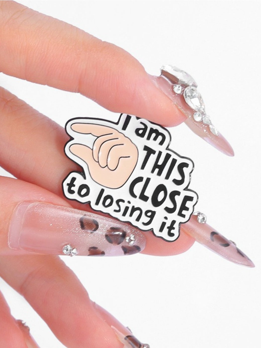 Back of Pinori pin badge showing metal pin and clasp mechanism