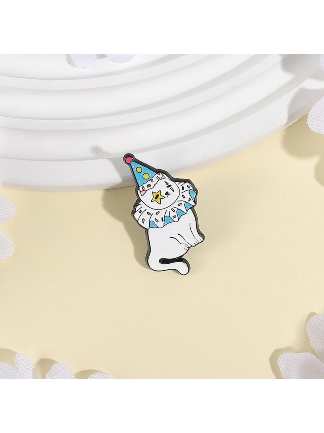 Side view of Pinori clown cat brooch highlighting metal pin clasp and enamel finish