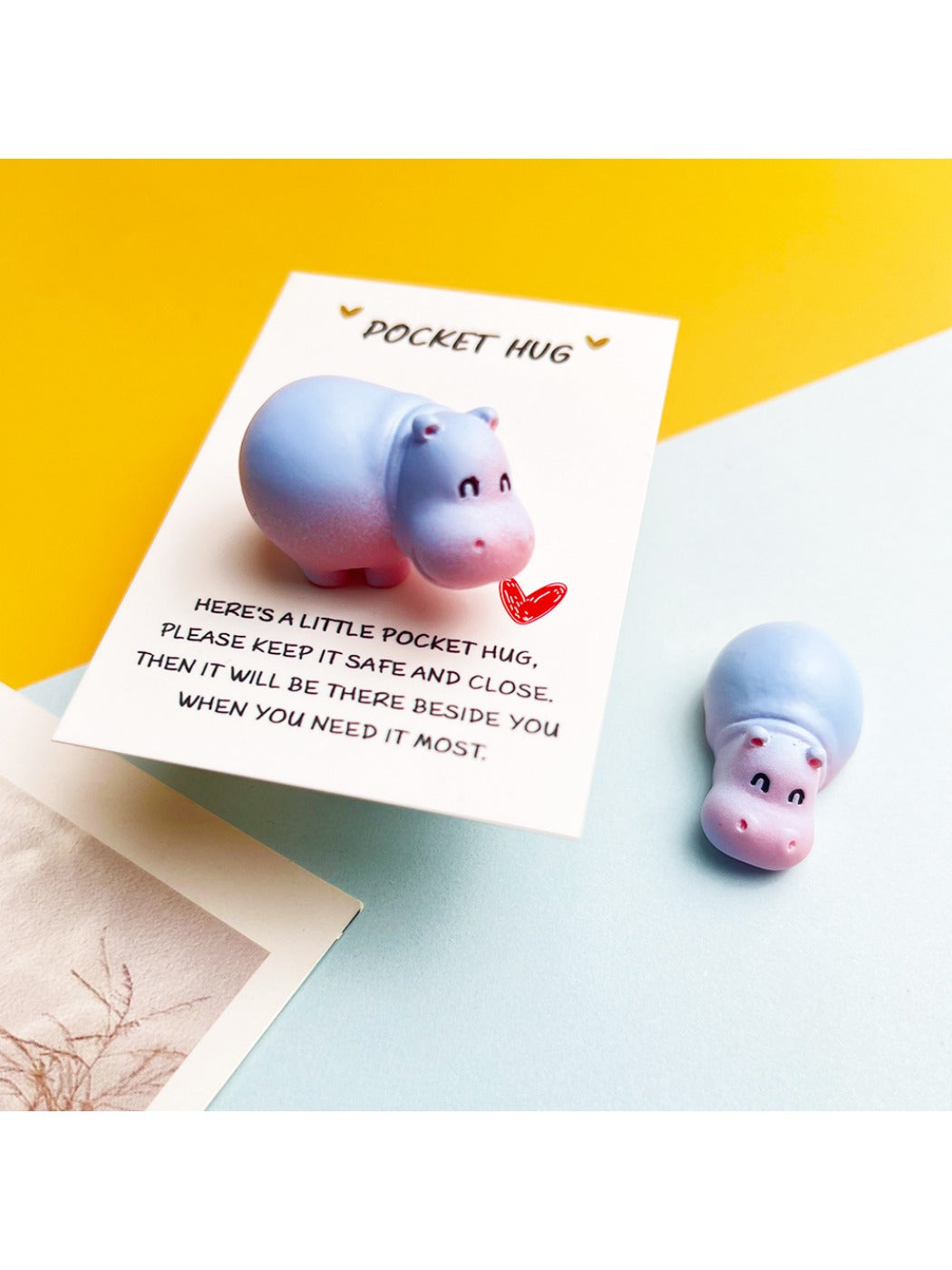 Close-up of Taphug Pocket Hug smiling hippo plush toy showing face details