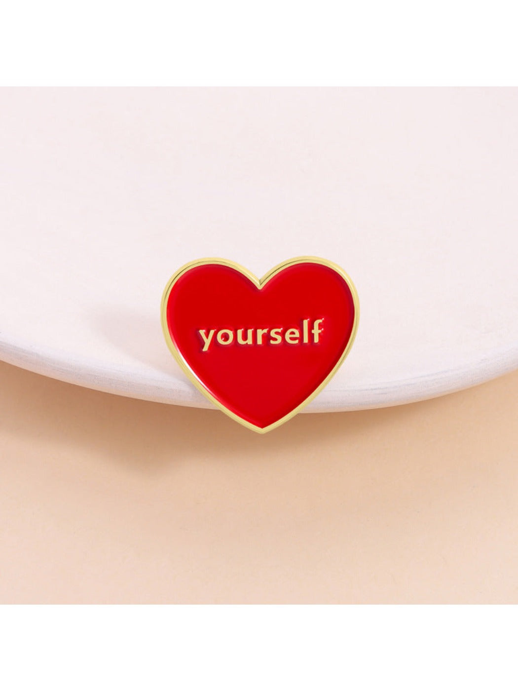 Pinori Love Yourself red heart brooch with gold outline on white background