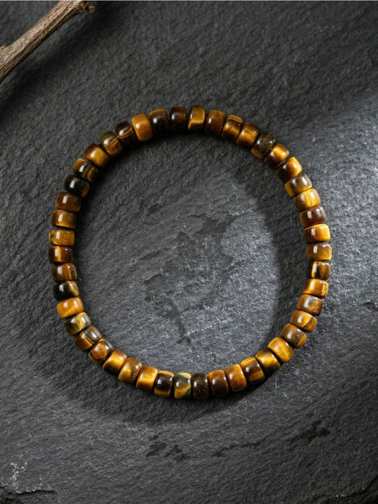 Close-up of Emora unisex bracelet with polished tiger eye beads and silver spacer beads