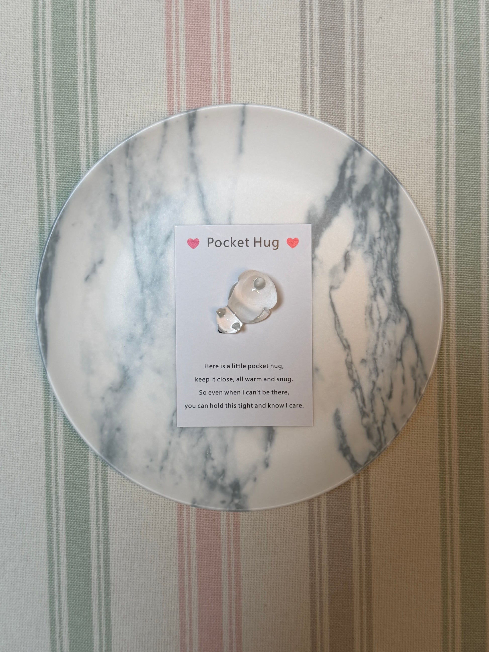 Small paper card beside a lightweight polyester polar bear token