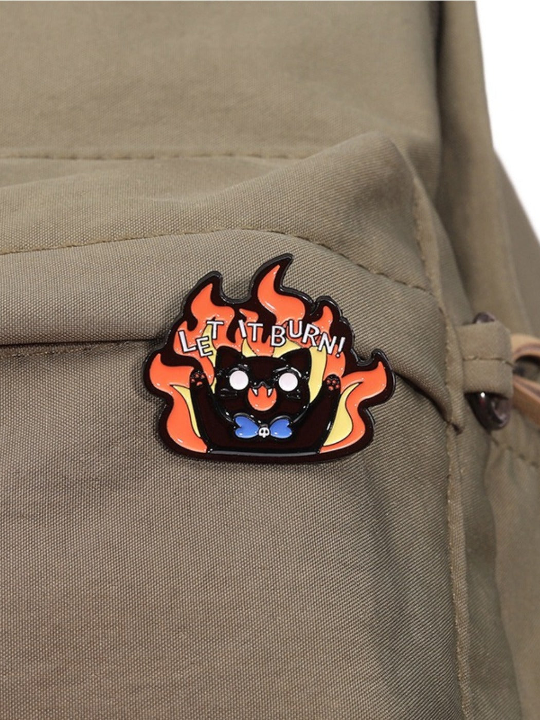 Side view of Pinori Evil Kitten brooch highlighting metal finish and flame details