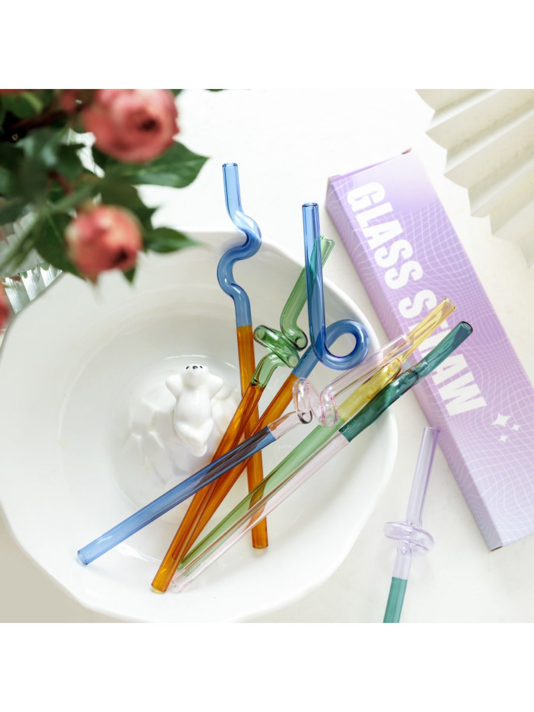 Close-up of Thimara colorful glass straws arranged in a gift box