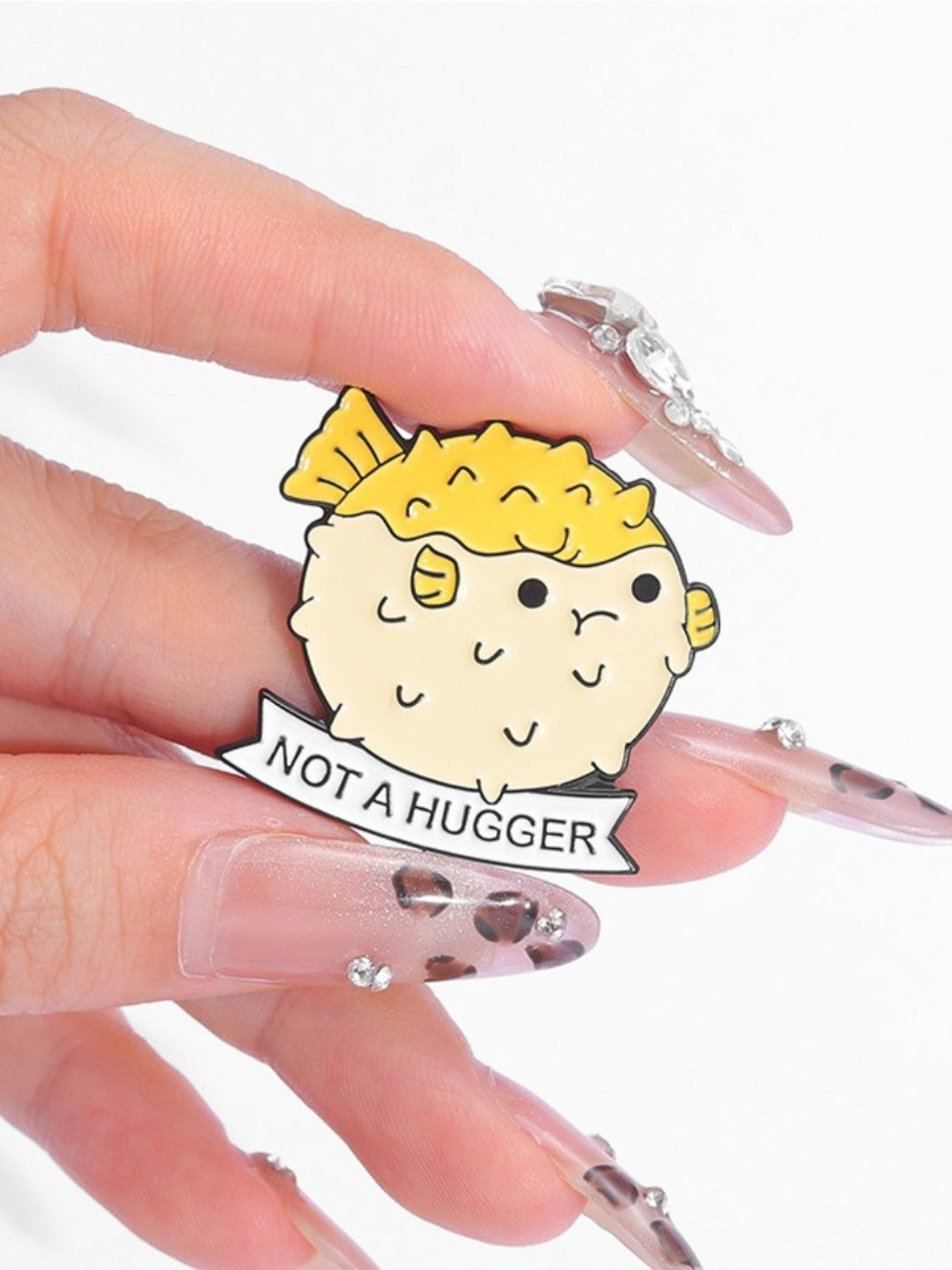 Frog puffer cactus pin held in hand to show size and scale