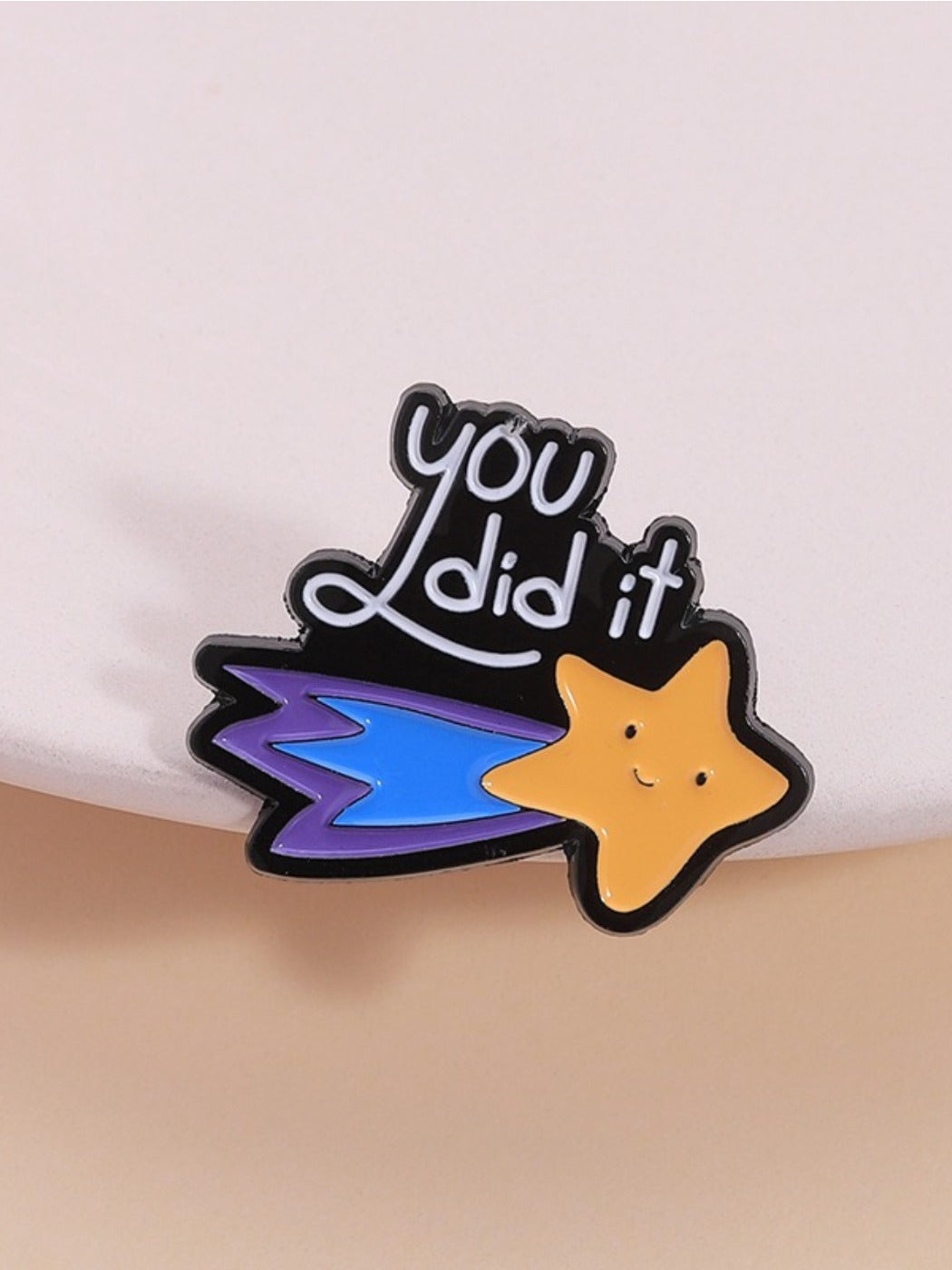 Close-up of Pinori trendy meteor shaped brooch with geometric star design on white background