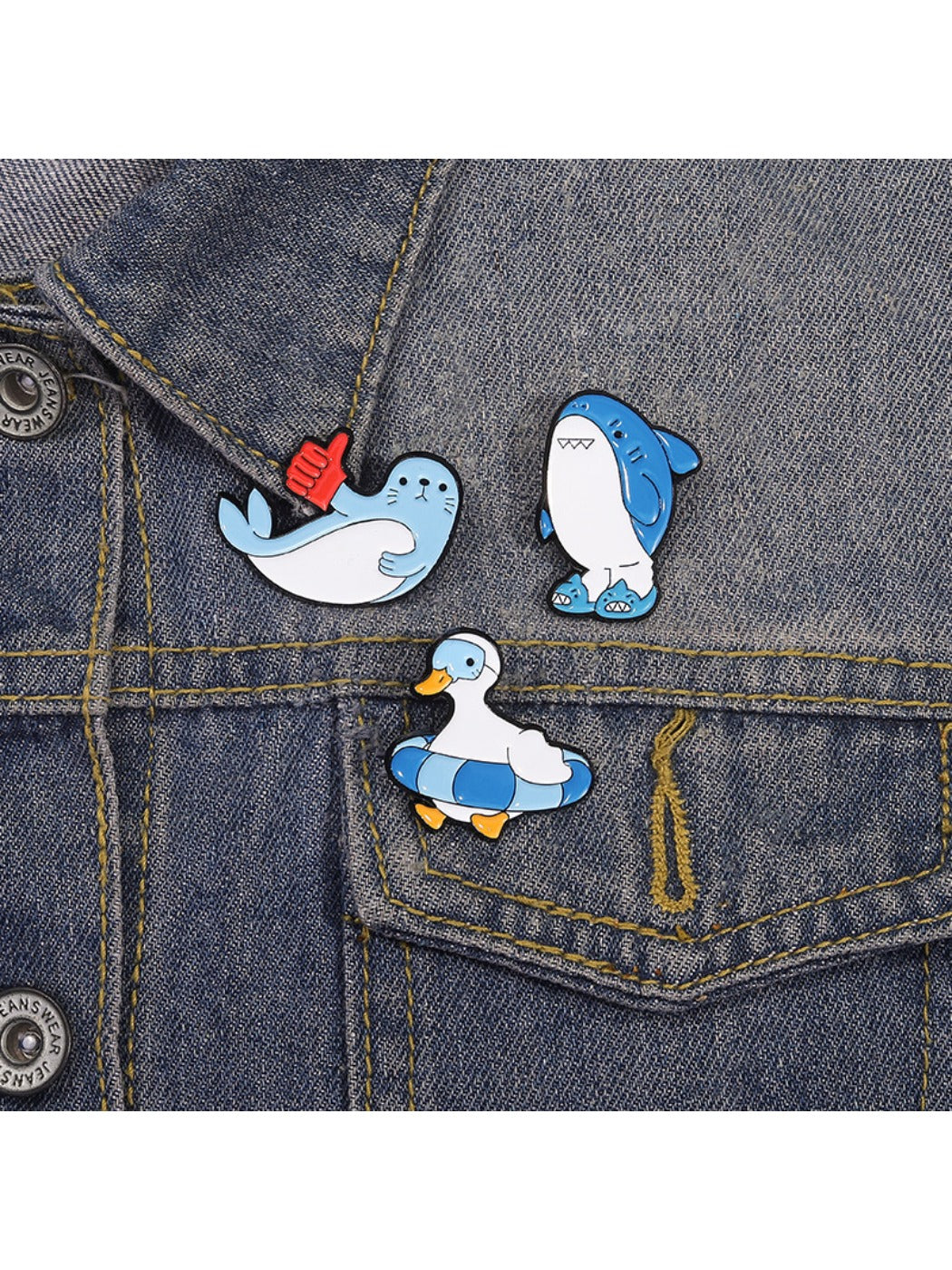 Shark brooch pinned on denim fabric highlighting its size and detail