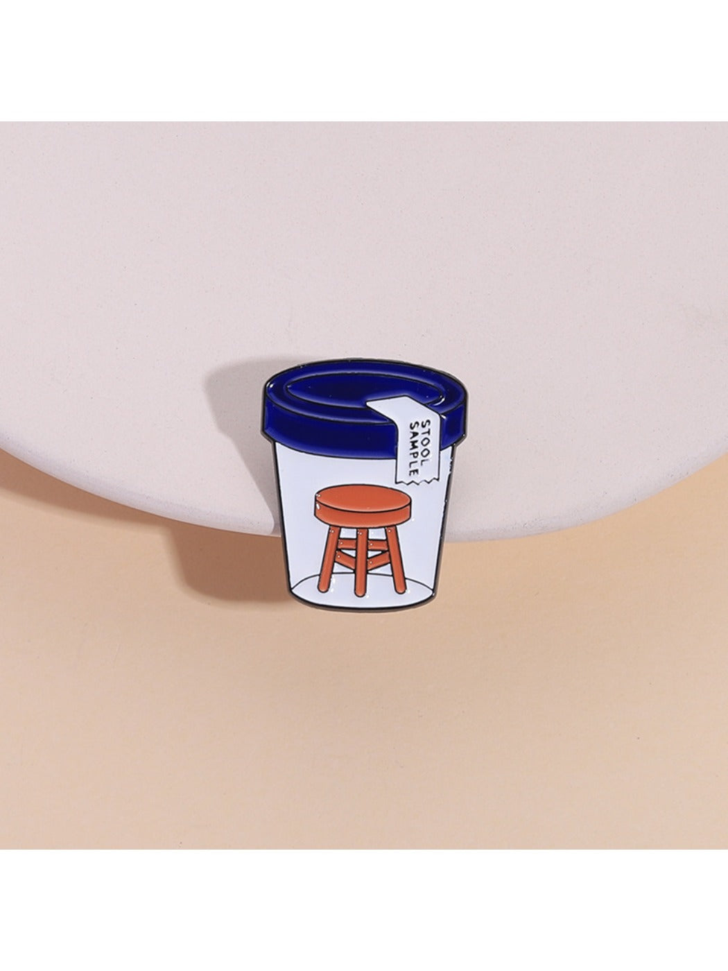 Pinori stool sample bottle pin badge on white background