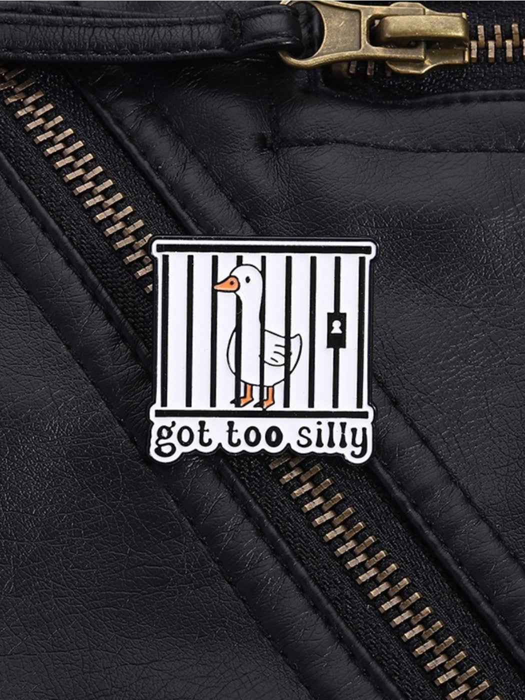 Pinori silly goose enamel pin attached to a denim jacket pocket for styling example