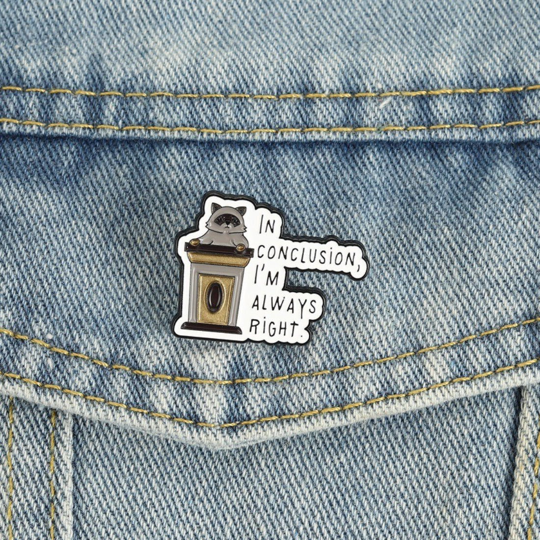 Back view of Pinori raccoon quote enamel pin showing metal pin clasp