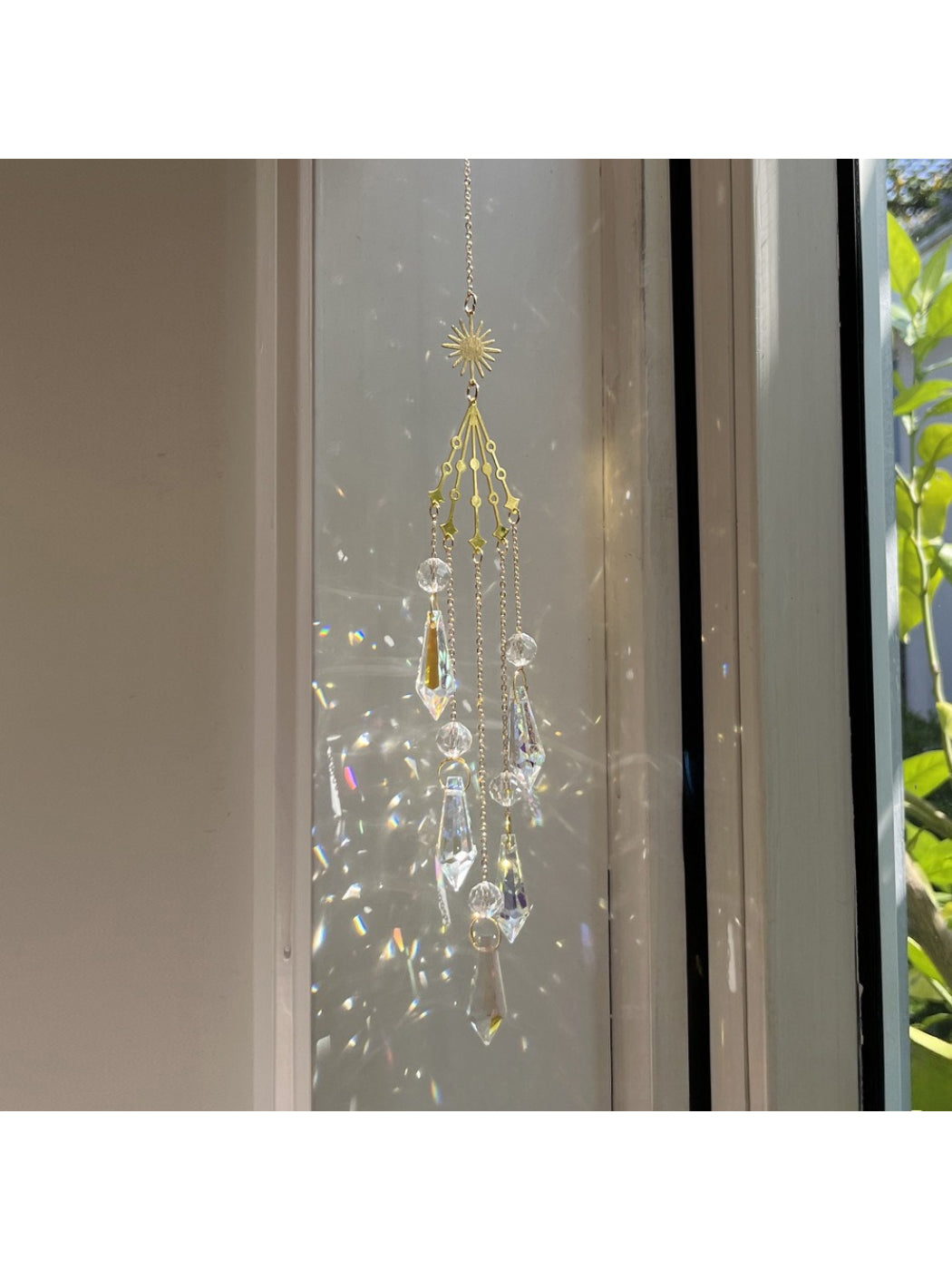 Close-up of Somnia Star Moon Rainbow Sun Catcher showing star and moon shapes