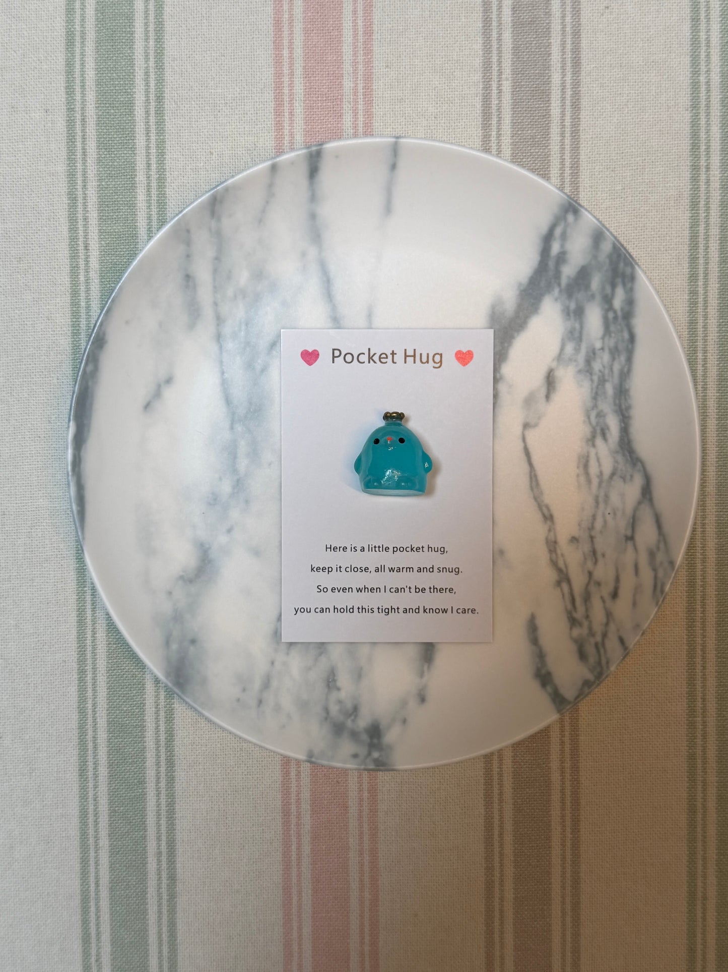 Multiple views of the crown chick pocket hug card and matching token