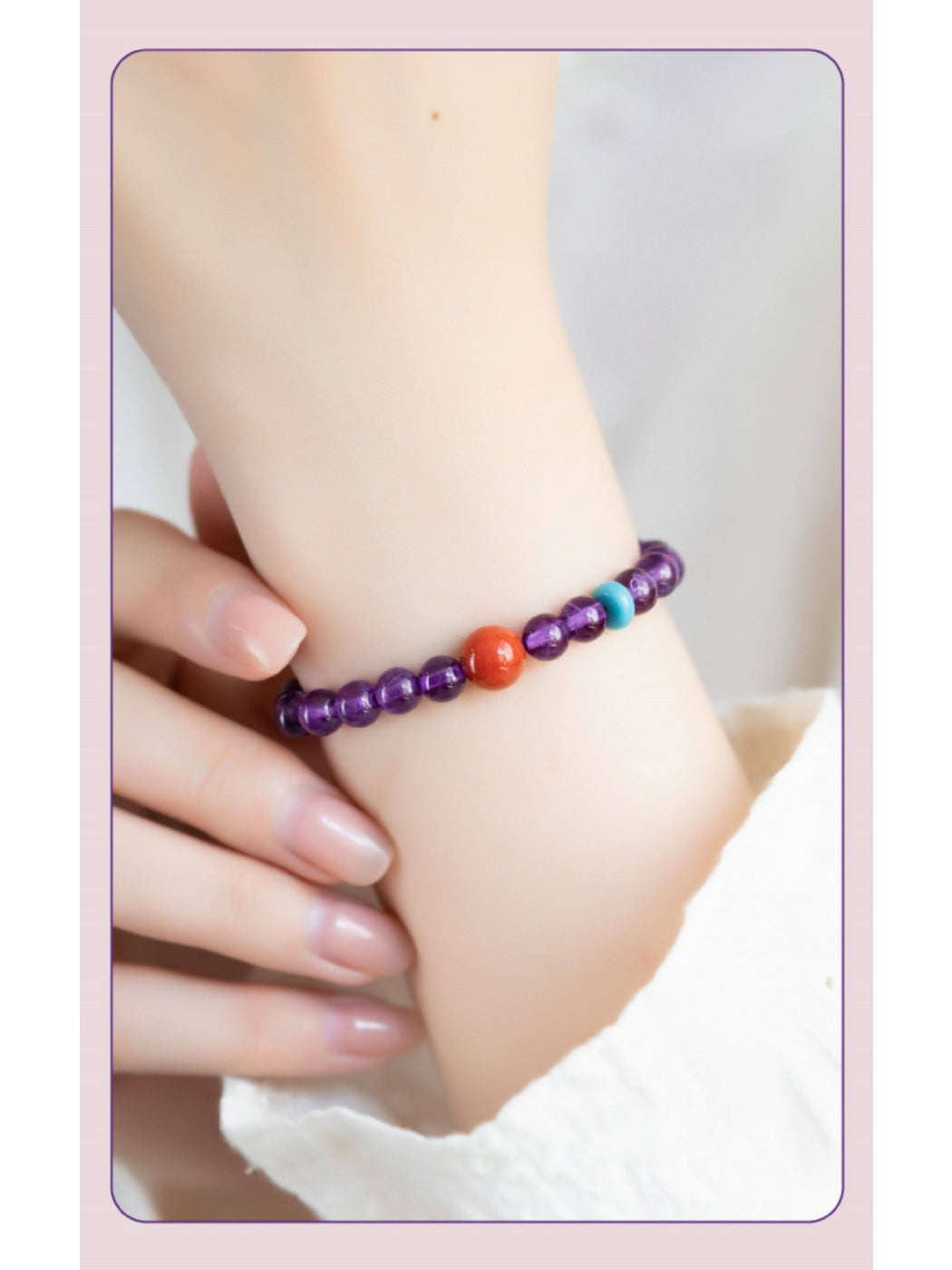 Emora bracelet worn on wrist showing purple amethyst stones and matching beads