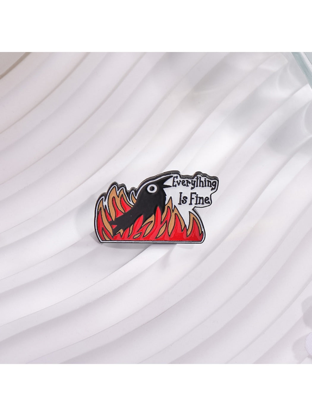 Side view of Gothic raven brooch highlighting flame pattern and metal texture