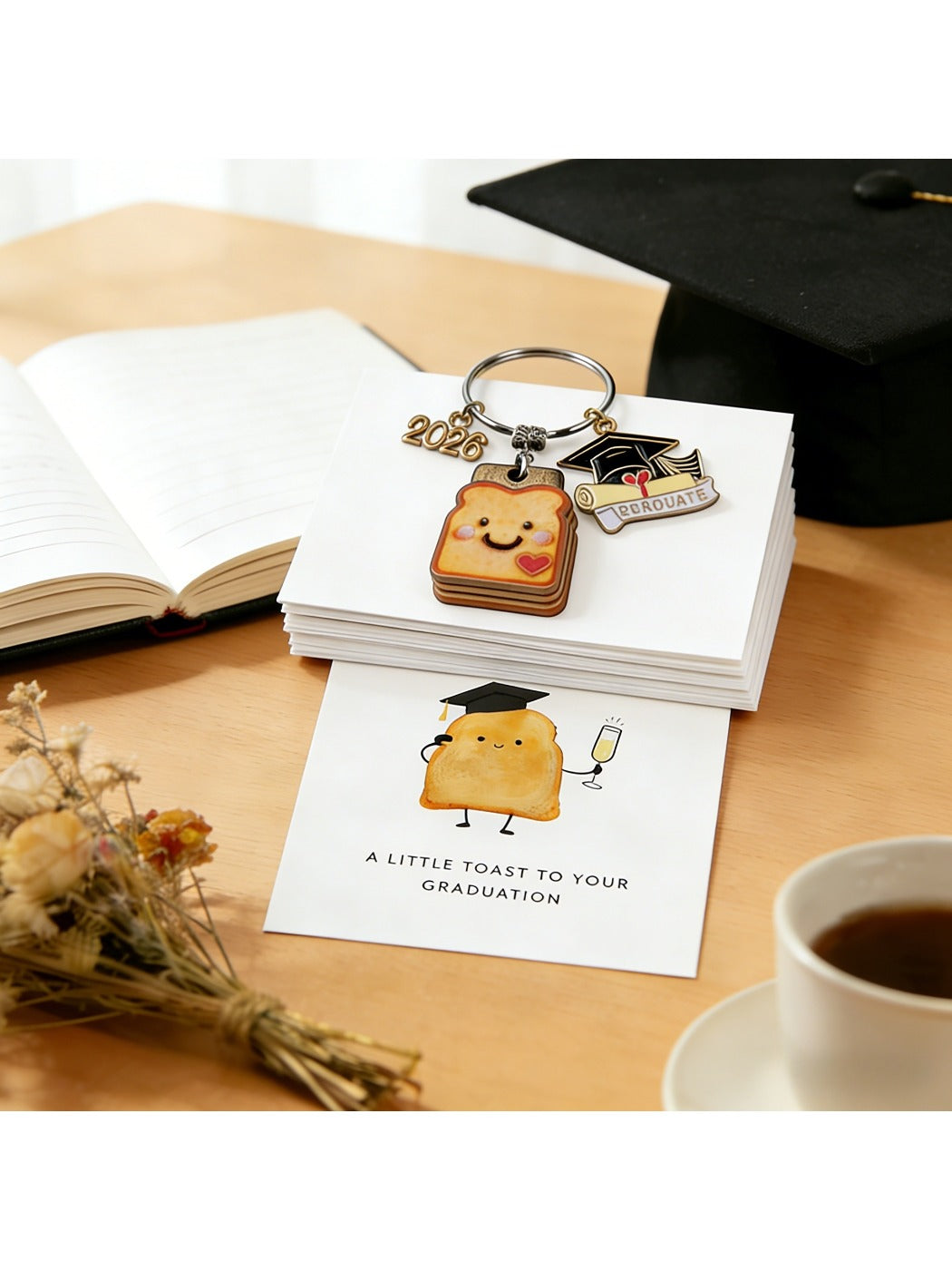 Taphug graduation keychain featuring a small resin bread cookie charm on a gold loop