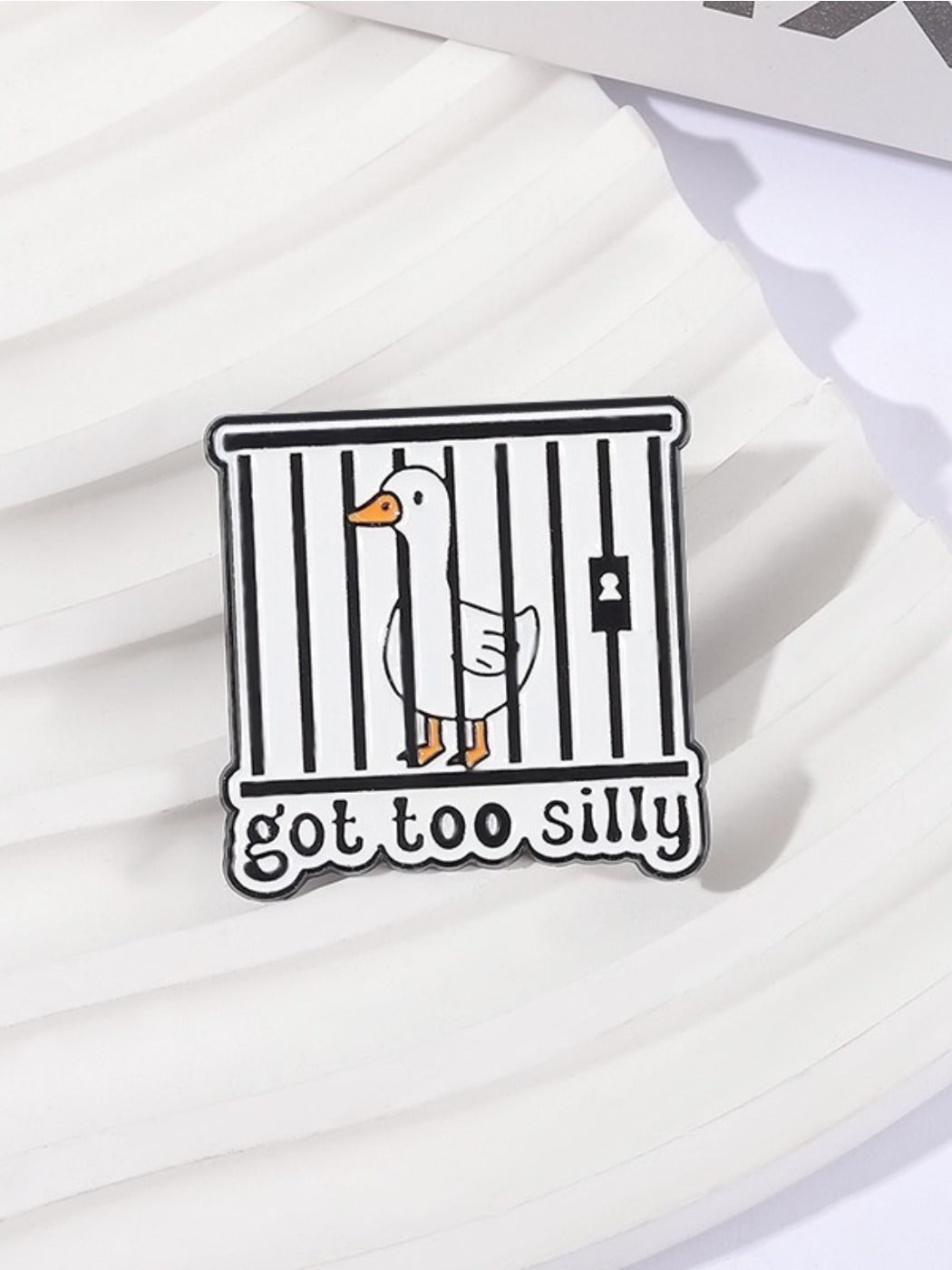 Close-up of Pinori silly goose enamel pin showing detailed facial expression and colors