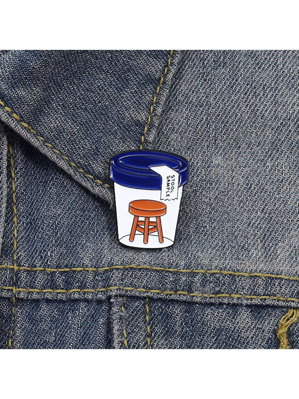 Pinori stool sample bottle pin badge displayed with other novelty pins