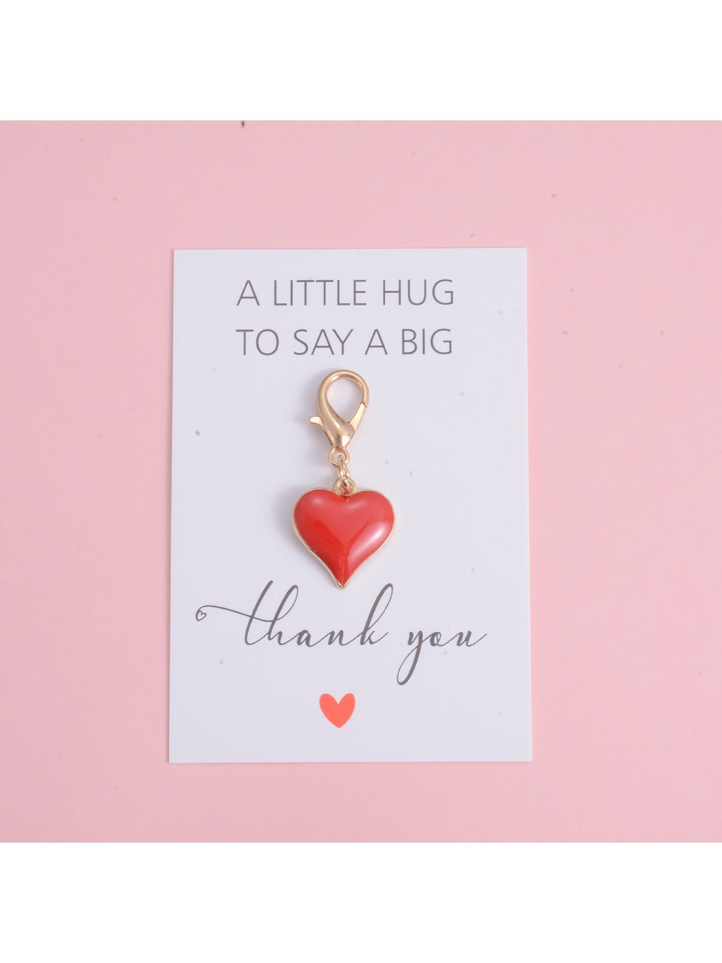 Close-up of Taphug heart pendant accessory charm showing detailed edges