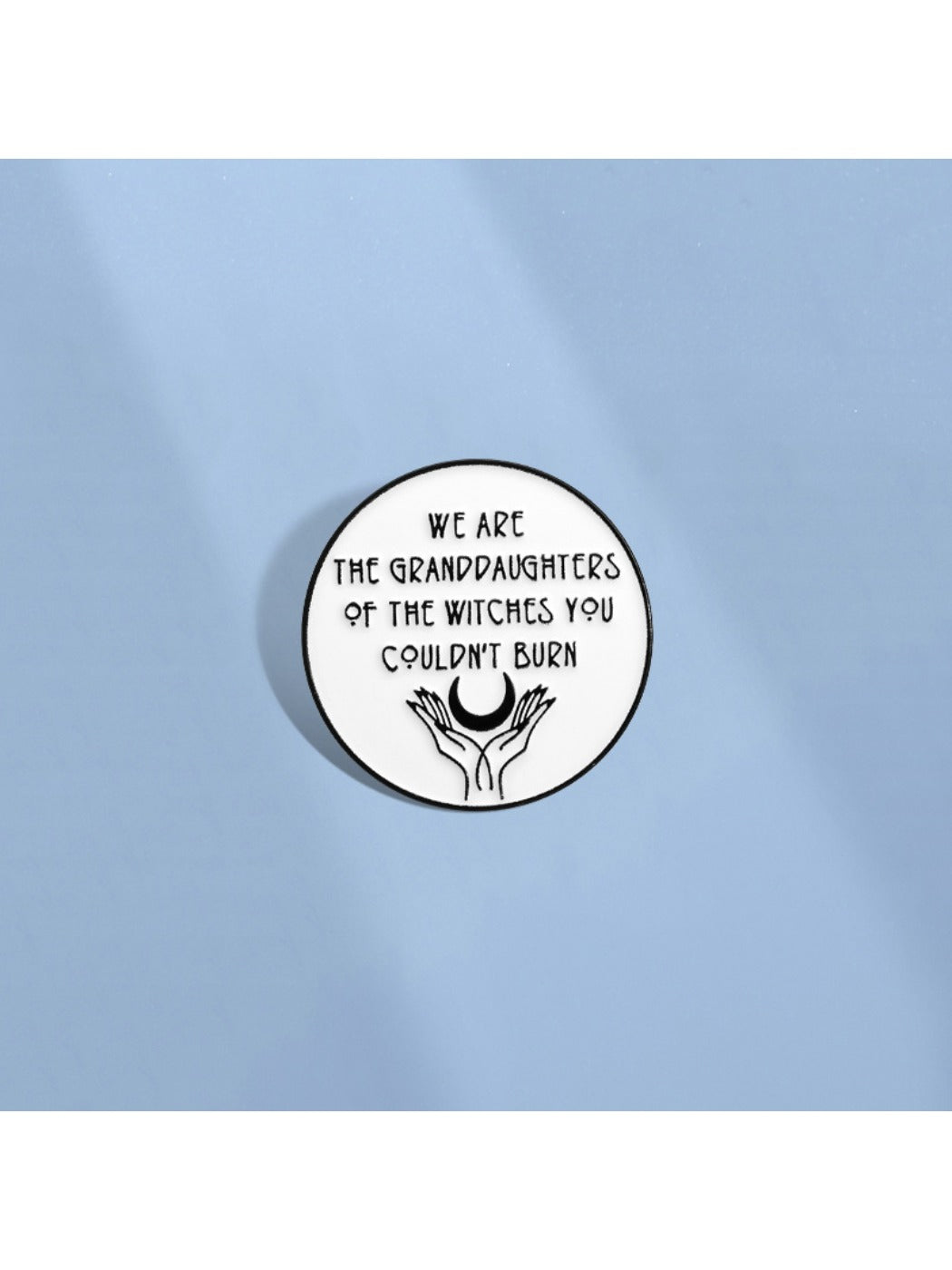 Pinori Girl Power Unburnable Badge Pin shown attached to denim fabric