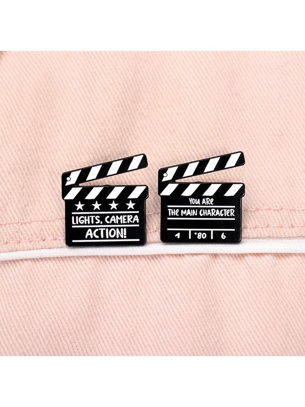 Pinori clapperboard brooch pinned on denim jacket pocket