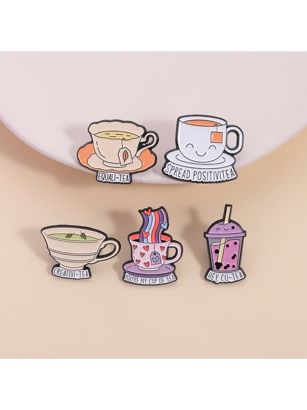 Close-up of Pinori tea cup pin showing detailed enamel colors and metal outline