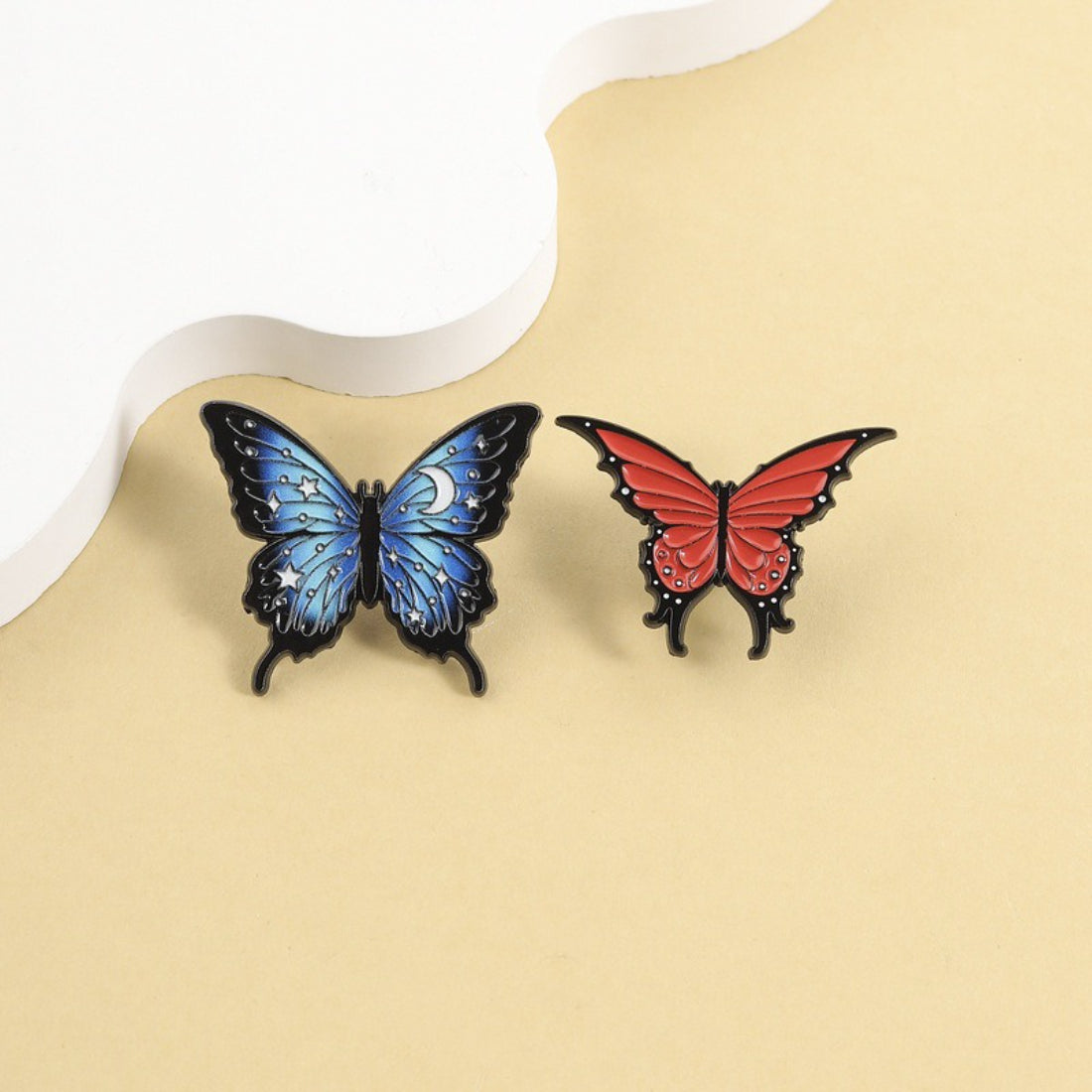 Close-up of Pinori Starry Wing Butterfly enamel pin with blue and gold details
