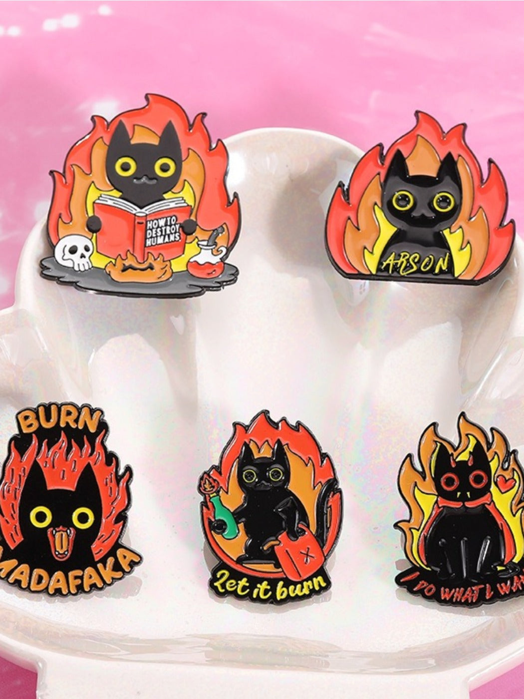 Close-up of Pinori black cat badge showing detailed flame pattern