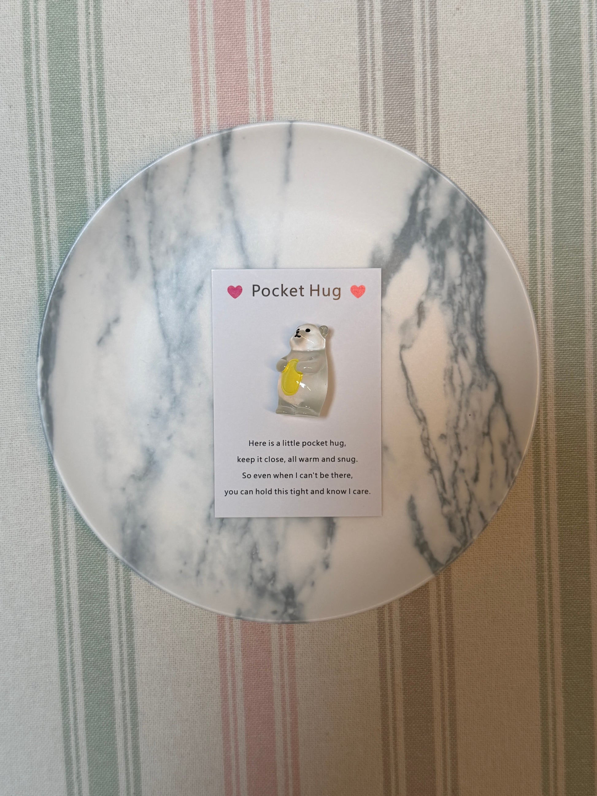 Pocket-sized card and polar bear token with simple printed artwork
