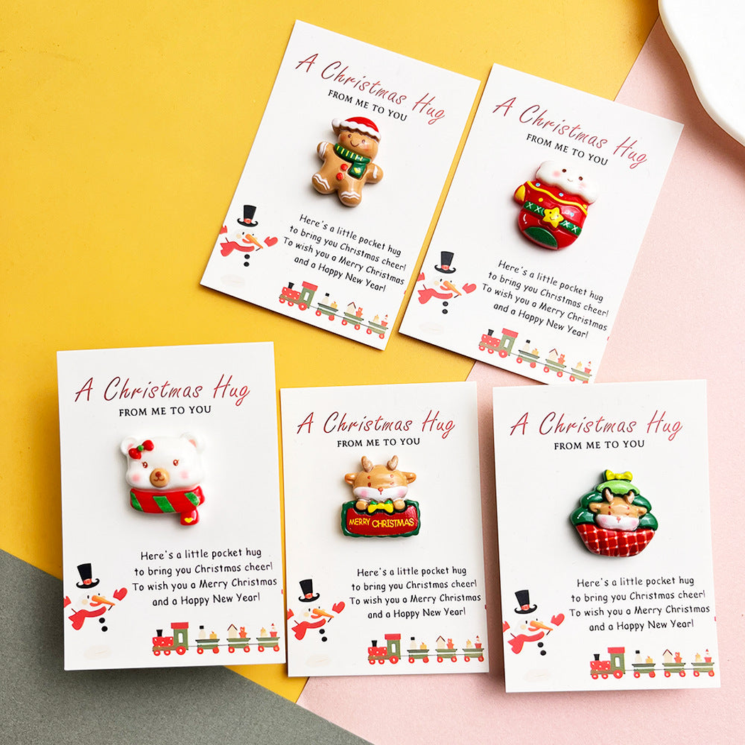 Five character-themed pocket hugs displayed on Christmas message cards