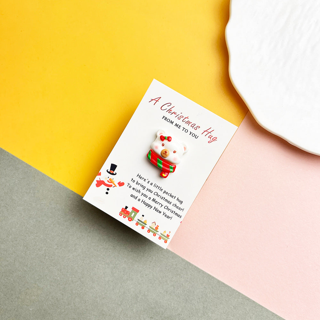 Scarf-wrapped bear pocket hug on a Christmas message card