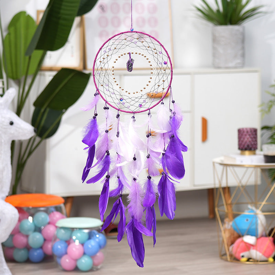 Purple dreamcatcher hanging in a bright interior setting